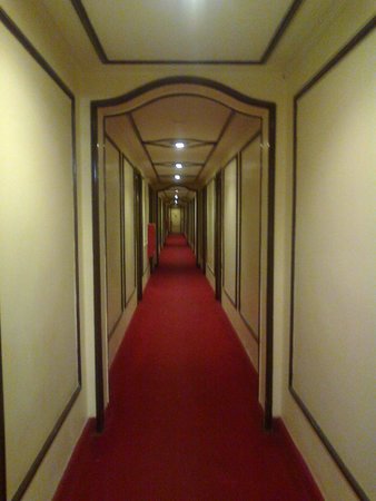 Un inquietante pasillo de hotel con una moqueta rojo sangre