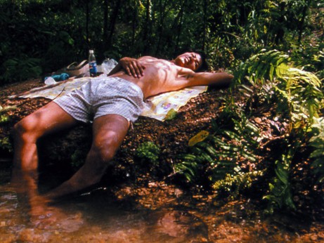 El protagonista descansa con los pies en el agua del río