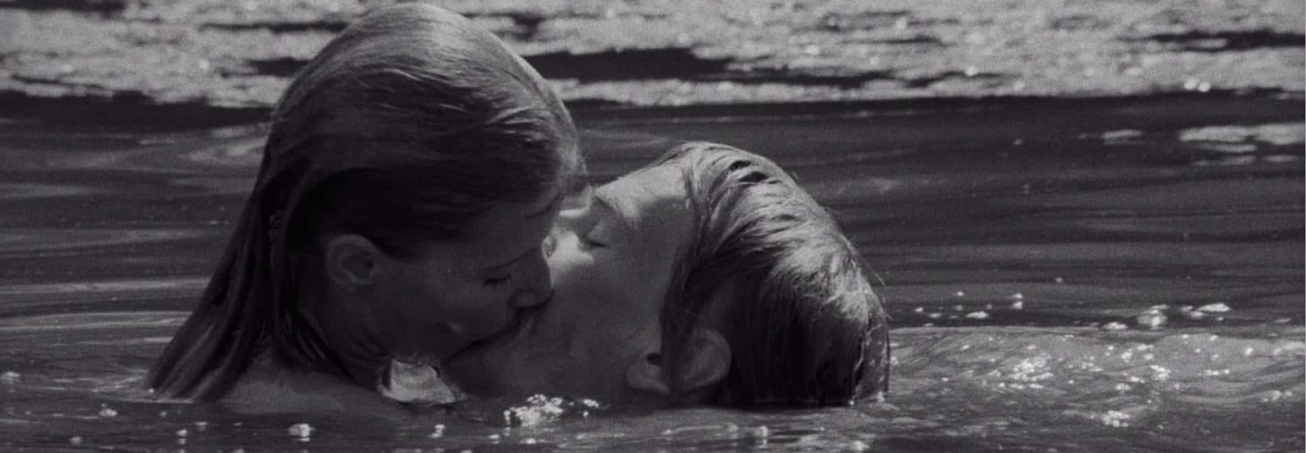 La pareja protagonista se besa dentro del agua